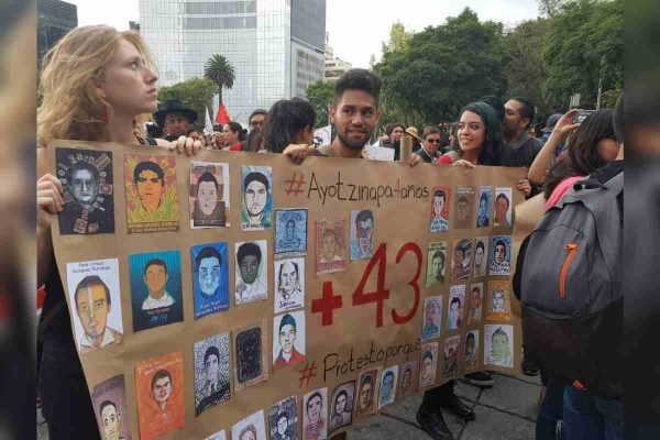 Participantes en la marcha para conmemorar el noveno aniversario de Ayotzinapa.